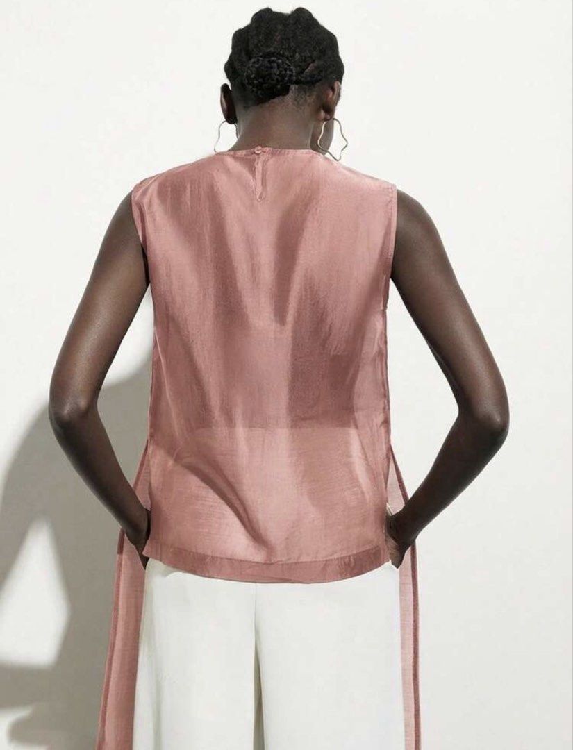 Dusty Pink Sheer Sleeveless Tunic Split Front (Category: Sleeveless) located in Muntinlupa City. Submitted by myabcshop (Listing ID 1467722089, Image 2). Description: - Color: Dusty pink - Design: Sleeveless tunic with sheer finish and center front split - Details: High round neckline and back button closure - Fit: Long length, lightweight with a slight sheen - Styling: Perfect for warm weather; wear solo or layer over trousers.