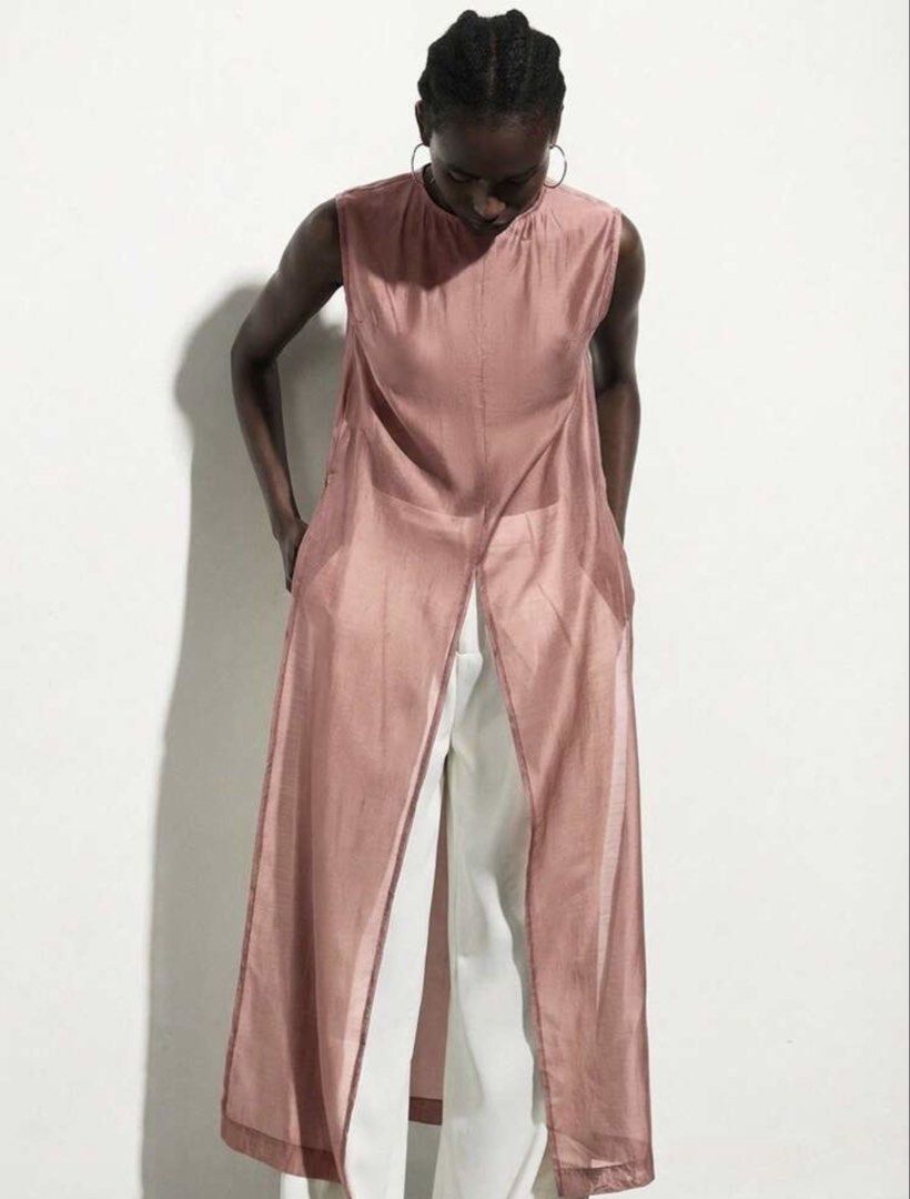 Dusty Pink Sheer Sleeveless Tunic Split Front (Category: Sleeveless) located in Muntinlupa City. Submitted by myabcshop (Listing ID 1467722089, Image 1). Description: - Color: Dusty pink - Design: Sleeveless tunic with sheer finish and center front split - Details: High round neckline and back button closure - Fit: Long length, lightweight with a slight sheen - Styling: Perfect for warm weather; wear solo or layer over trousers.