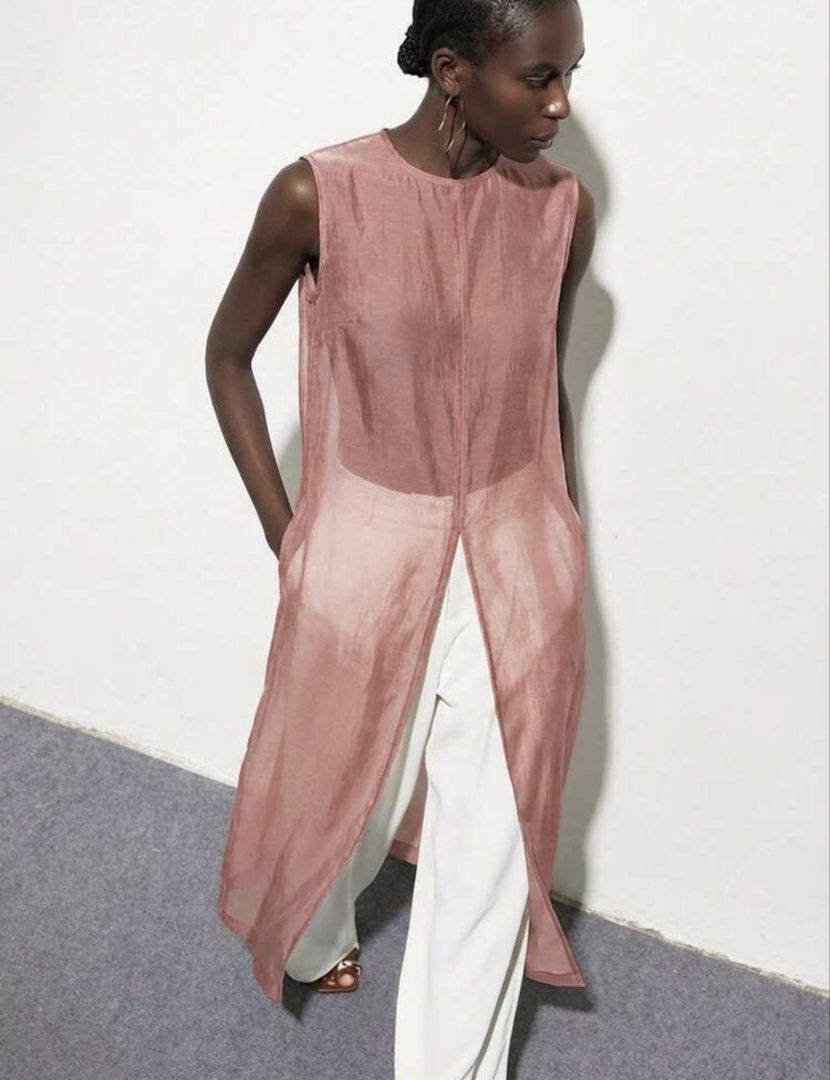 Dusty Pink Sheer Sleeveless Tunic Split Front (Category: Sleeveless) located in Muntinlupa City. Submitted by myabcshop (Listing ID 1467722089, Image 3). Description: - Color: Dusty pink - Design: Sleeveless tunic with sheer finish and center front split - Details: High round neckline and back button closure - Fit: Long length, lightweight with a slight sheen - Styling: Perfect for warm weather; wear solo or layer over trousers.