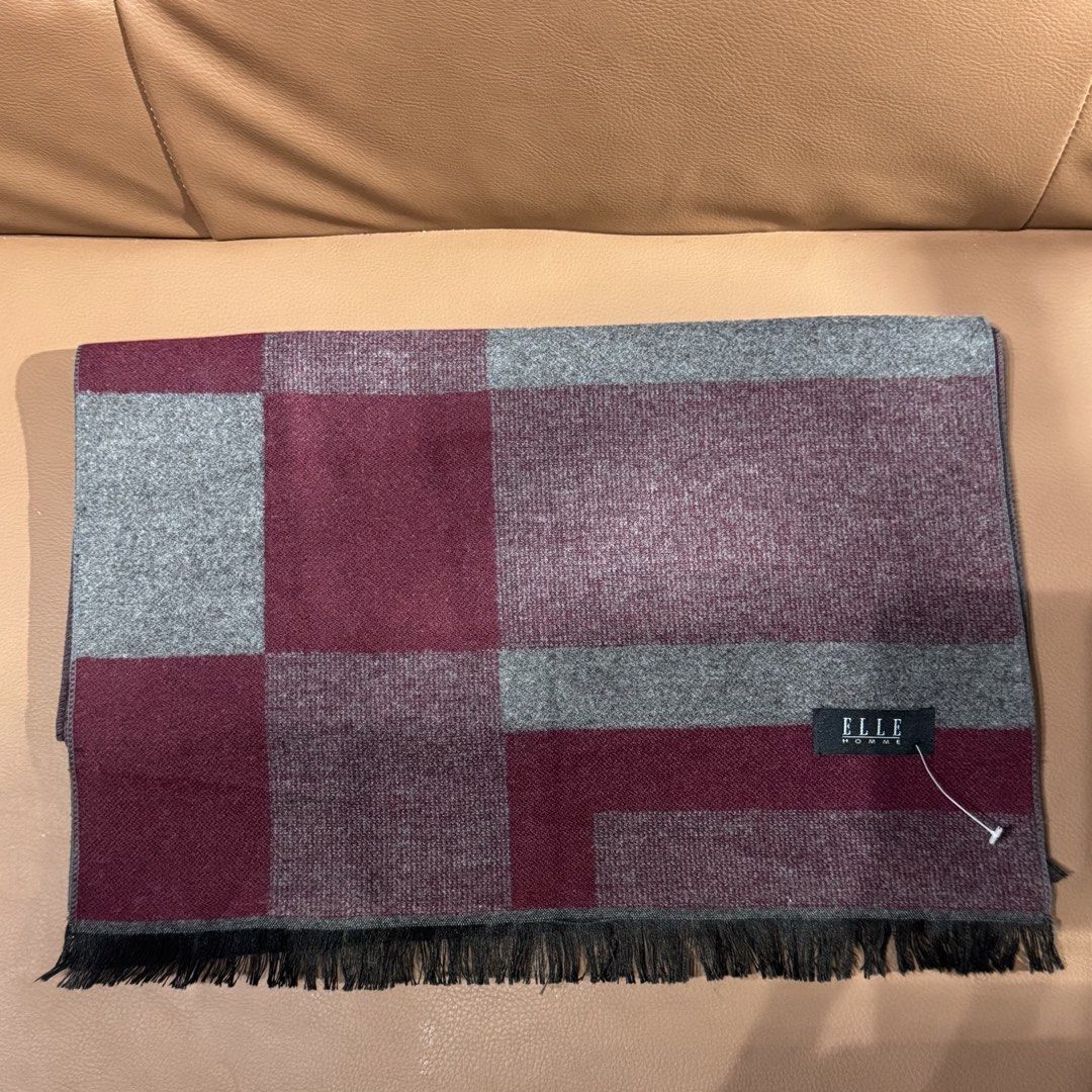 ELLE Homme Maroon and Grey Patterned Scarf (Category: Scarves) located in Rizal. Submitted by houseofbell (Listing ID 1467606925, Image 2). Description: - Brand: ELLE Homme - Condition: Brand new with tag attached - Color: Maroon and grey - Design: Stylish block pattern with fringe details at both ends - Material: Soft and cozy knit fabric for cold weather - Perfect for winter travels or chilly days.
