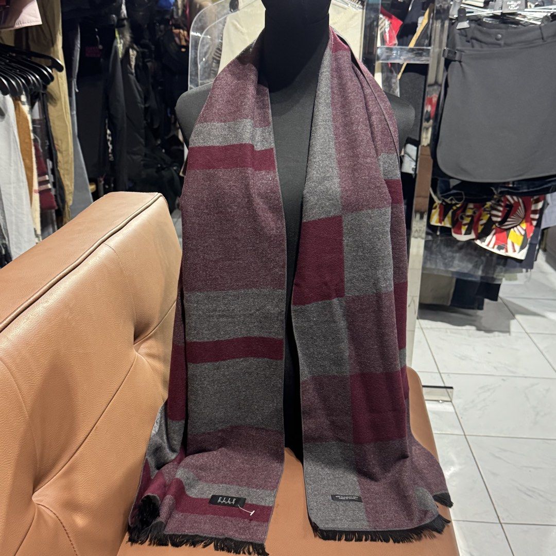 ELLE Homme Maroon and Grey Patterned Scarf (Category: Scarves) located in Rizal. Submitted by houseofbell (Listing ID 1467606925, Image 3). Description: - Brand: ELLE Homme - Condition: Brand new with tag attached - Color: Maroon and grey - Design: Stylish block pattern with fringe details at both ends - Material: Soft and cozy knit fabric for cold weather - Perfect for winter travels or chilly days.