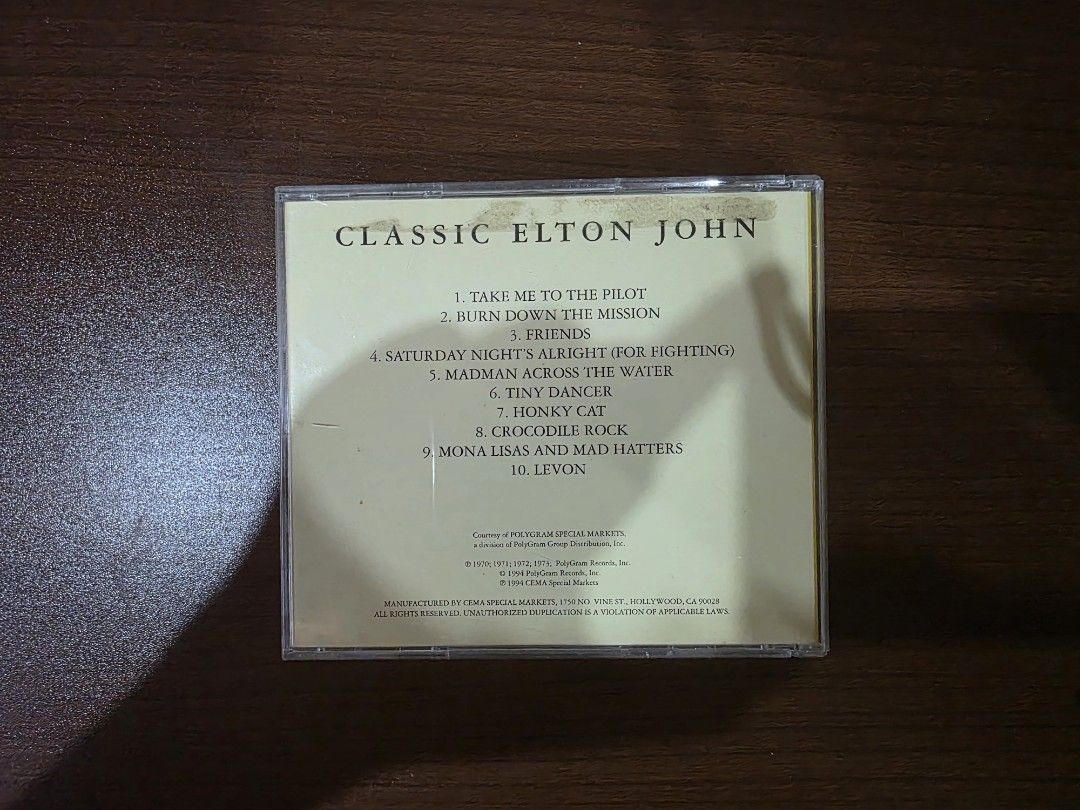 Elton John - Classic Elton John (CD) (Category: CDs & DVDs) located in Camalig. Submitted by kyoudayo (Listing ID 1467700754, Image 2). Description: - Title: Classic Elton John Music Album - Release: 1994 by CEMA Special Markets - Tracklist: Includes 10 hits like Tiny Dancer, Crocodile Rock, and Saturday Night's Alright - Bonus: Includes rare vintage promo insert from Sam Goody, Musicland, and On-Cue - Condition: VG+, some cracks on jewel case.