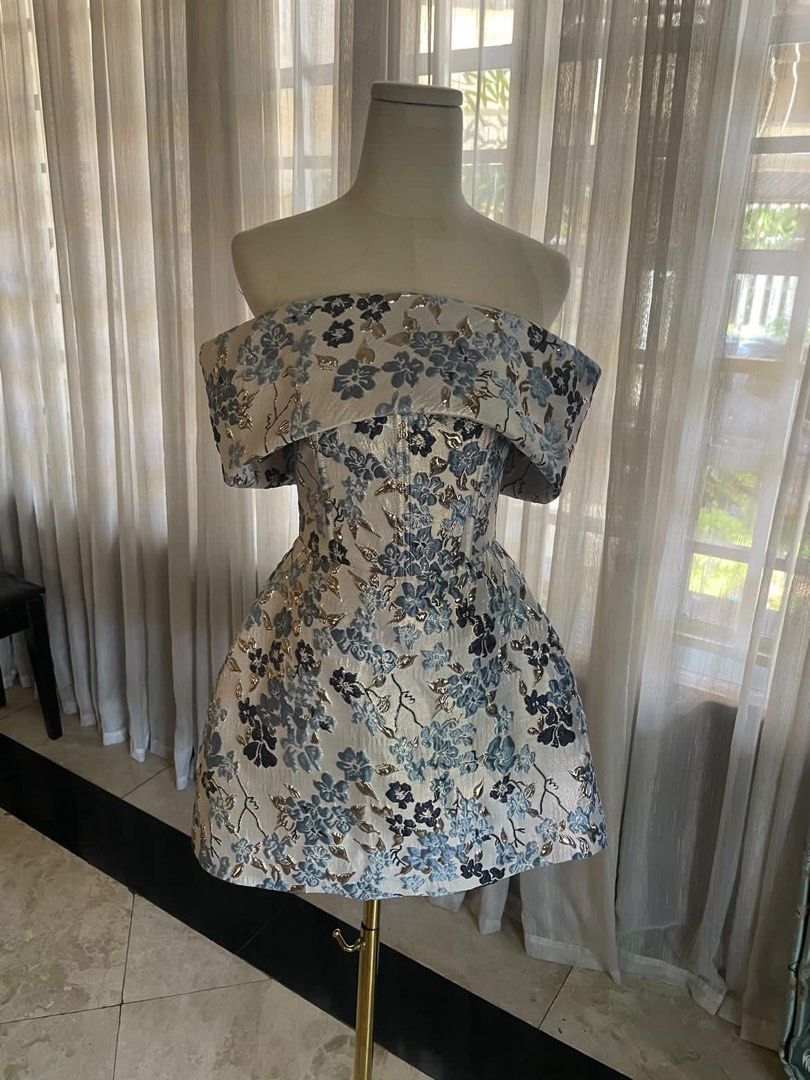 Emilia Dress (Category: Dresses) located in Quezon City. Submitted by nanabananie (Listing ID 1467650865, Image 1). Description: Preloved Custom-Made Floral Brocade Dress Selling my custom-made floral brocade dress, originally purchased for ₱3,599. ✨ Worn only once ✨ Very good condition ✨ Elegant blue and silver floral pattern ✨ Off-shoulder neckline with a structured bodice ✨ RFS: No longer fits me Measurements: * Bust: 31” * Waist: 26” * Hips: 