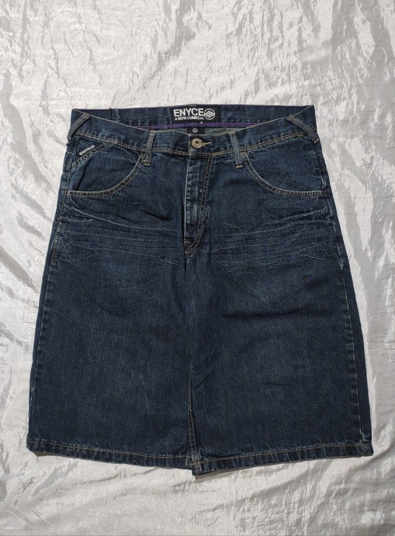 Enyce Denim Skirt Size 34 (Category: Skirts) located in Binan City. Submitted by mmrl_rmwl00 (Listing ID 1467794813, Image 2). Description: Dark blue denim skirt from Enyce a Sean Combs co. Size 34 tag inside. 100 percent cotton, made in Pakistan. Embroidered gold logo on the back pocket. Leather brand patch at the back waistband. Purple contrast stitching details along the inside waistband and seams. Five pocket styling with button closure and z