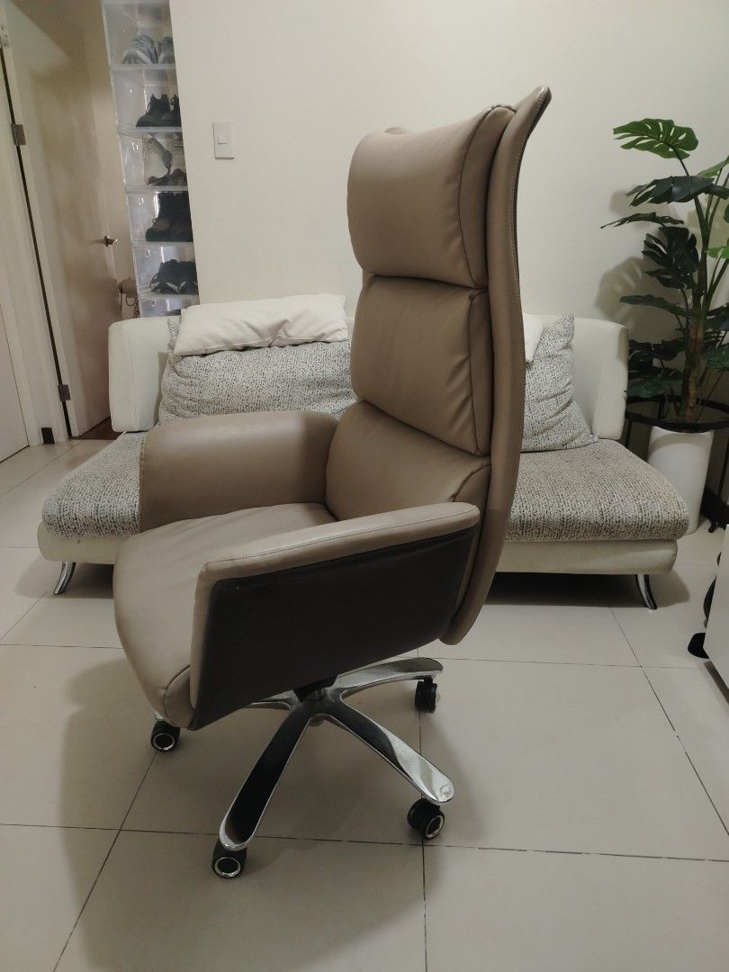 Ergonomic High Back Executive Office Chair Beige Brown (Category: Office Furniture & Fixtures) located in Pasig City. Submitted by juniort2001 (Listing ID 1467668908, Image 2). Description: - Elegant executive high-back office chair in beige and dark brown leatherette - Thick padded cushioning on the seat, backrest, and headrest for maximum all-day support - Sturdy chrome star base equipped with smooth-rolling caster wheels - Fully functional hei