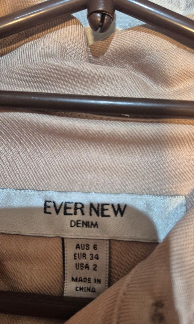 EVER NEW Nude linen romper (Category: Dresses) located in Taguig. Submitted by declutter_it420 (Listing ID 1467736915, Image 2). Description: - Color: Nude/beige - Material: Comfortable linen-blend - Design: classic collar and front button placket - Features: Two chest pockets and a flattering matching waist tie belt - Length: Hits right above the knee - Perfect for: Summer days and casual outings.