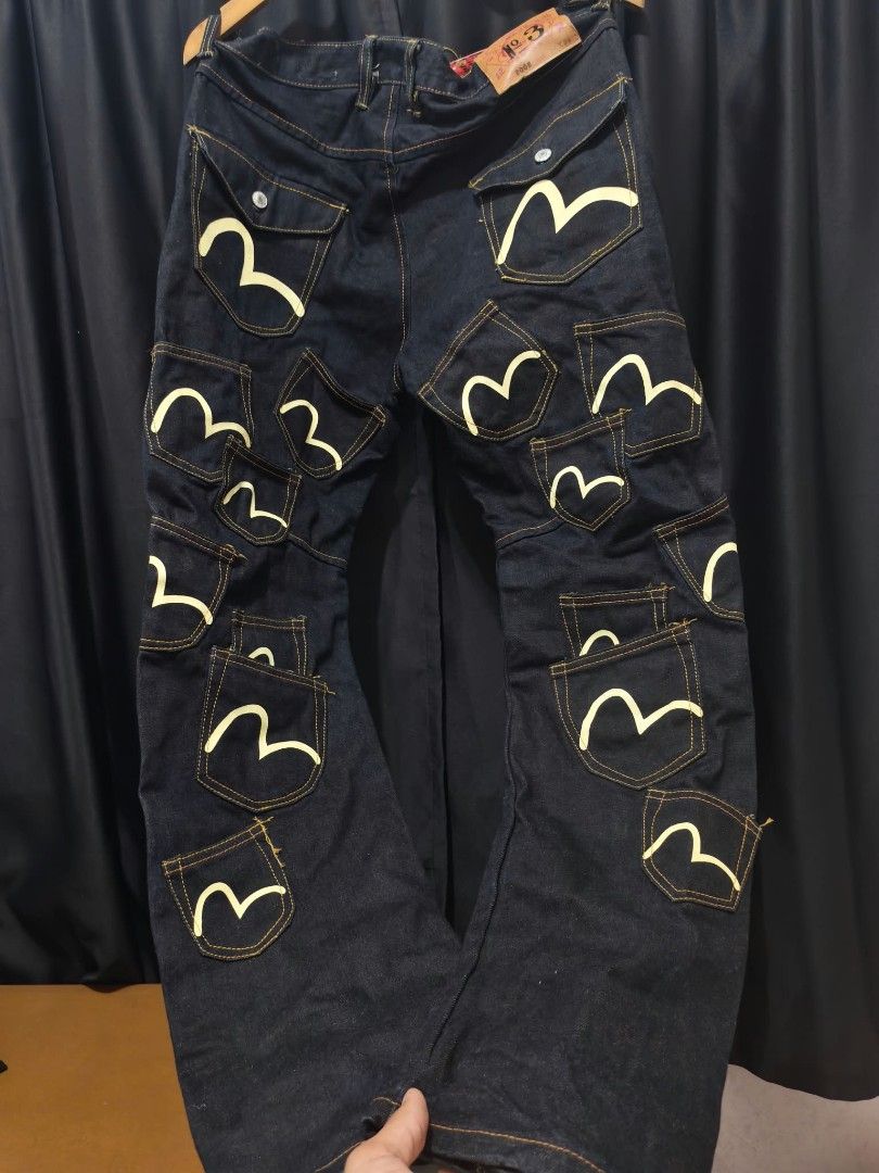 Evisu Multi Pocket Dark Denim Jeans 36x34 (Category: Jeans) located in Baguio. Submitted by solo_ukay (Listing ID 1467788271, Image 1). Description: Rare Evisu dark denim jeans covered in multiple pockets with painted gull logos. Red tartan plaid inner waistband lining. Tagged size 36 by 34. Button fly closure. Unique statement piece with lots of storage detail all over the legs. Heavyweight denim fabric..