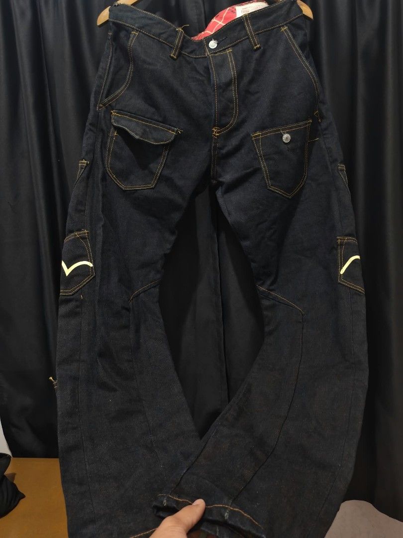 Evisu Multi Pocket Dark Denim Jeans 36x34 (Category: Jeans) located in Baguio. Submitted by solo_ukay (Listing ID 1467788271, Image 2). Description: Rare Evisu dark denim jeans covered in multiple pockets with painted gull logos. Red tartan plaid inner waistband lining. Tagged size 36 by 34. Button fly closure. Unique statement piece with lots of storage detail all over the legs. Heavyweight denim fabric..
