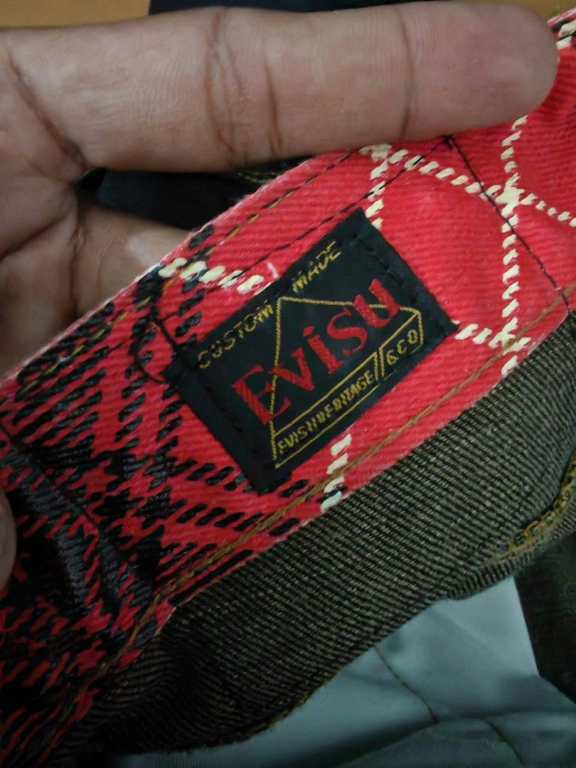 Evisu Multi Pocket Dark Denim Jeans 36x34 (Category: Jeans) located in Baguio. Submitted by solo_ukay (Listing ID 1467788271, Image 3). Description: Rare Evisu dark denim jeans covered in multiple pockets with painted gull logos. Red tartan plaid inner waistband lining. Tagged size 36 by 34. Button fly closure. Unique statement piece with lots of storage detail all over the legs. Heavyweight denim fabric..