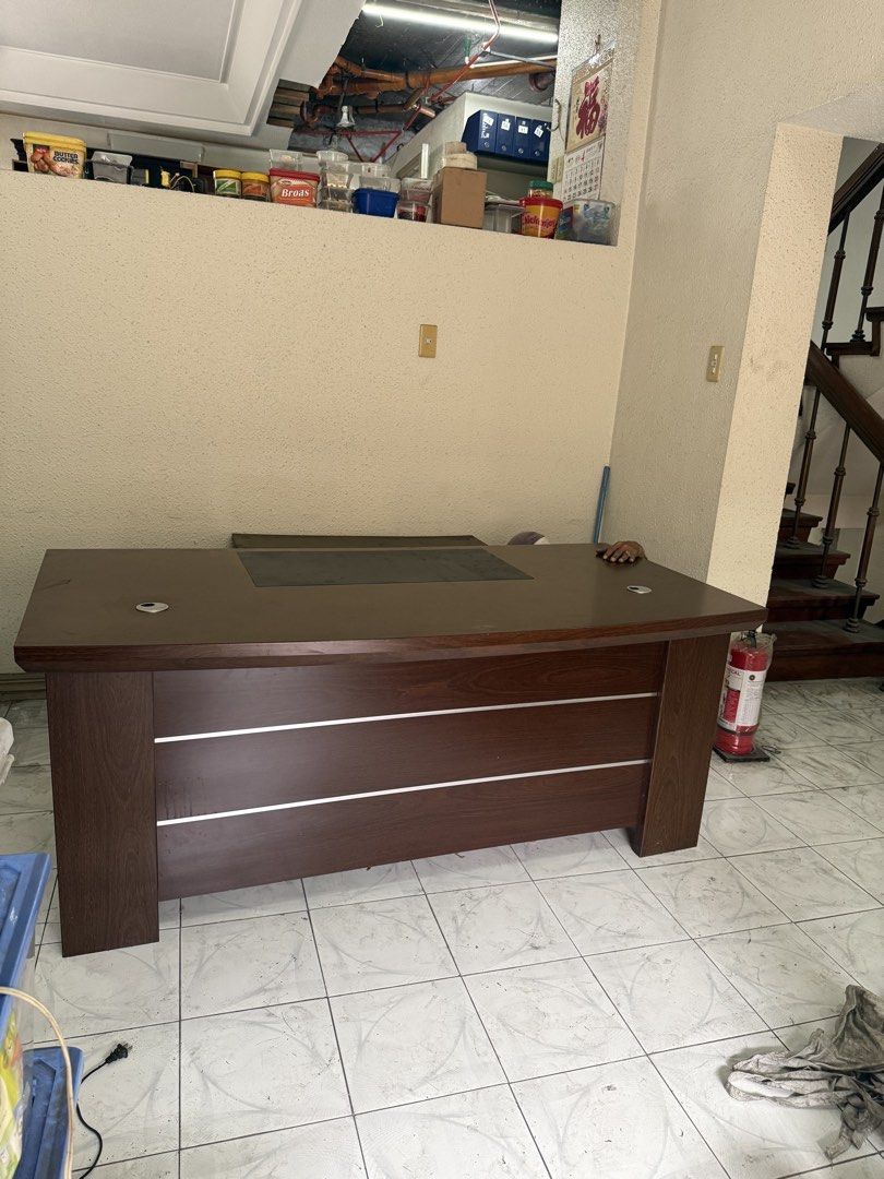 Executive wooden office desk with silver accent lines (Category: Tables & Sets) located in Quezon City. Submitted by goldenwolf.1dbda9 (Listing ID 1467617691, Image 1). Description: - Dark wood finish with 3 sleek silver accent lines on the front - Premium dark leatherette insert centered on the top surface - 2 built-in wire management grommets on top (left and right) - Solid block legs for a sturdy and stable build - Clean appearance, perfect fo