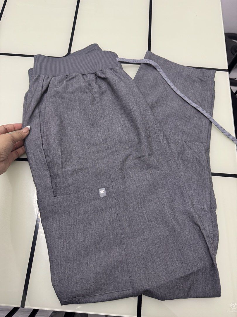 Fabletics Grey Scrubs Jogger Pants Size L (Category: Joggers) located in Arayat. Submitted by janeng_ba10fd (Listing ID 1467620474, Image 1). Description: - Brand: Fabletics - Size: Large - Color: Heather Grey - Waistband: Ribbed elastic with adjustable drawstring - Pockets: Multiple utility pockets including a back pocket and cargo side pocket - Origin: Made in Vietnam - Condition: Clean, excellent, ready to wear - Ideal for: Healthcare work shi