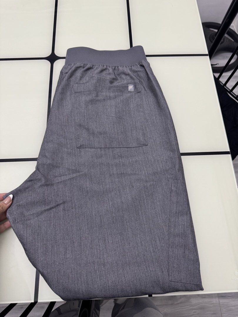 Fabletics Grey Scrubs Jogger Pants Size L (Category: Joggers) located in Arayat. Submitted by janeng_ba10fd (Listing ID 1467620474, Image 2). Description: - Brand: Fabletics - Size: Large - Color: Heather Grey - Waistband: Ribbed elastic with adjustable drawstring - Pockets: Multiple utility pockets including a back pocket and cargo side pocket - Origin: Made in Vietnam - Condition: Clean, excellent, ready to wear - Ideal for: Healthcare work shi
