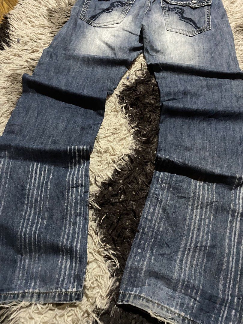 Fairwhale Jeans Blue Denim Size 30 Y2K Flared (Category: Jeans) located in Manila. Submitted by coollion.19b40f (Listing ID 1467775107, Image 3). Description: - Brand: Fairwhale - Size: 30 (170/75A) - Material: 100% cotton - Waist: Mid-rise with heavy contrast stitching - Details: Washed finish with whiskering - Pockets: Button flap back pockets and embroidered cross coin pocket - Style: Decorative vertical striping patterns down the lower legs.