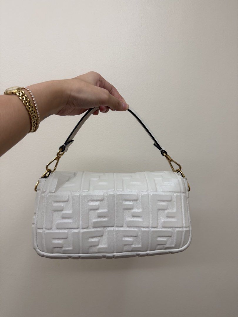 Fendi White Leather Embossed FF Monogram Baguette Handbag (Category: Luxury Bags & Wallets) located in Manila. Submitted by tashvintagefinds (Listing ID 1467747955, Image 2). Description: - Authentic Fendi Baguette - White leather - Gold Hardware - With short and long strap - Good condition - with entrupy and dustbag - highly nego.