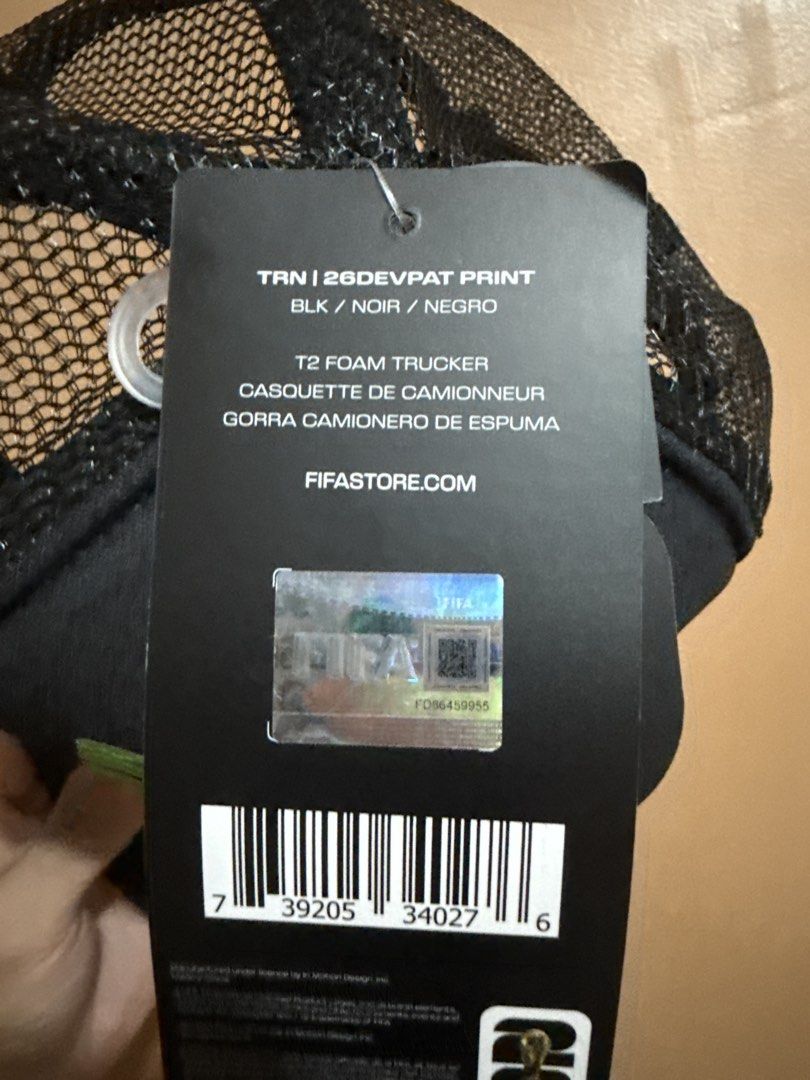 FIFA World Cup 26 T2 Poly Mesh Foam Trucker Hat (Category: Caps & Hats) located in Dasmarinas. Submitted by great______finds (Listing ID 1467709141, Image 3). Description: - Official licensed FIFA World Cup 2026 merchandise - Brand new with original tags attached - Color: Black with multi-colored trophy graphic on front foam panel - Breathable mesh back panels with adjustable snap closure - Great collectible item for the upcoming tournament.
