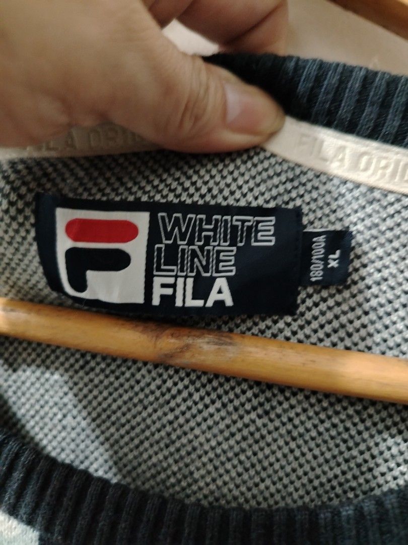 FILA White Line Checkered Knitted Sweater XL (Category: Coats, Jackets and Outerwear) located in Manila. Submitted by zyclothing03 (Listing ID 1467743112, Image 2). Description: - Brand: FILA White Line - Size: XL - Material: 60% cotton, 40% rayon (thick knit) - Design: Checkered pattern, bold chest logo, and lower typography details - Features: Ribbed collar, cuffs, and hem - Condition: Great for cooler weather.