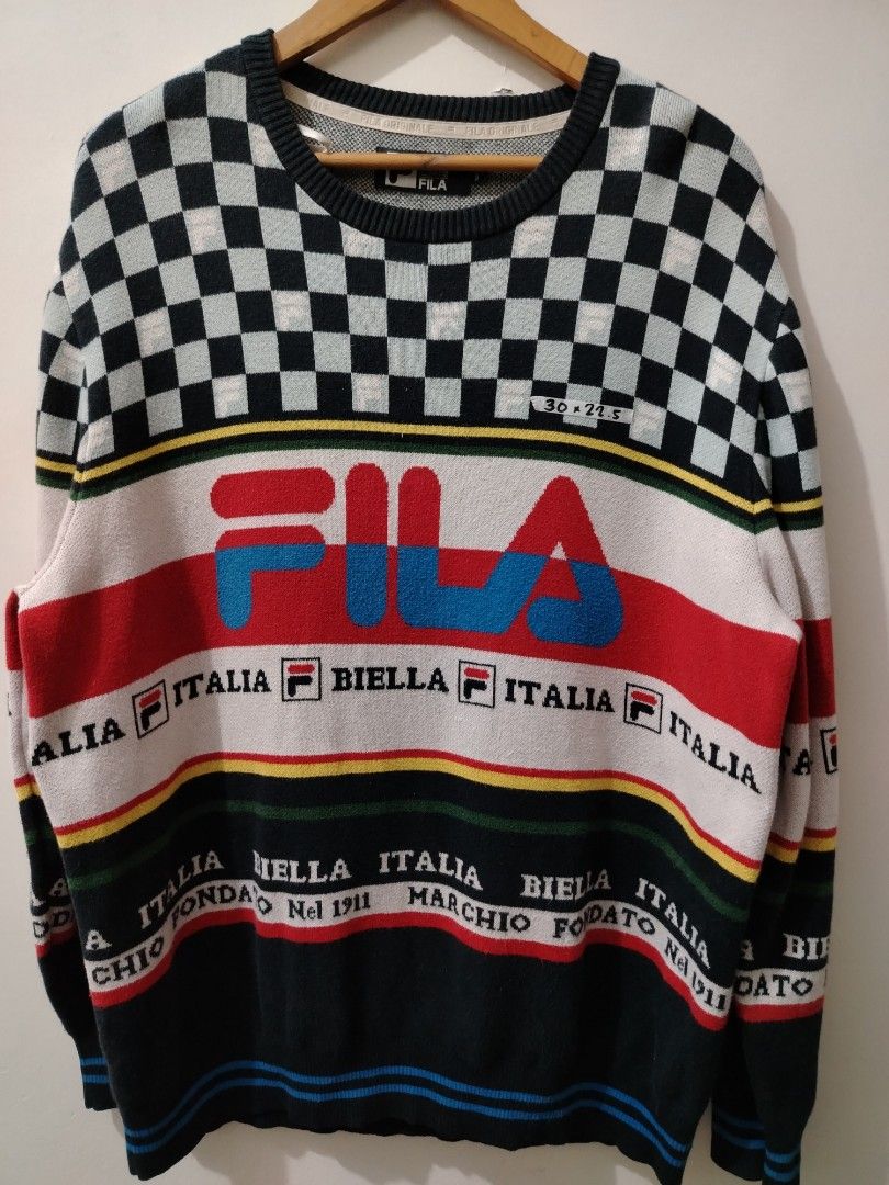 FILA White Line Checkered Knitted Sweater XL (Category: Coats, Jackets and Outerwear) located in Manila. Submitted by zyclothing03 (Listing ID 1467743112, Image 1). Description: - Brand: FILA White Line - Size: XL - Material: 60% cotton, 40% rayon (thick knit) - Design: Checkered pattern, bold chest logo, and lower typography details - Features: Ribbed collar, cuffs, and hem - Condition: Great for cooler weather.