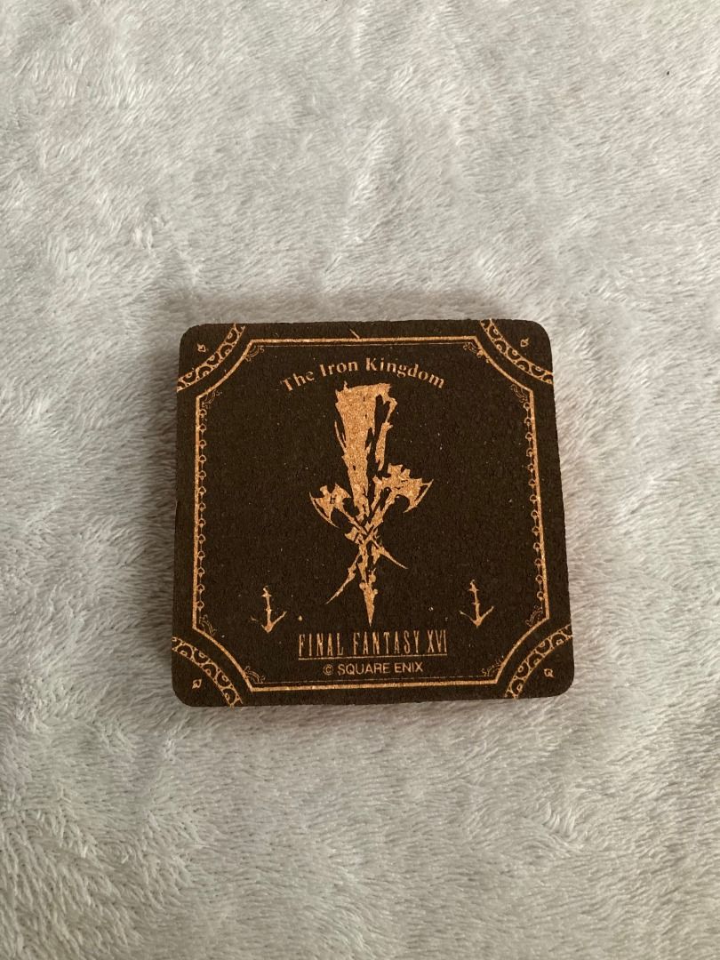 Final Fantasy XVI Iron Kingdom Cork Coaster Square (Category: Vintage Collectibles) located in Rizal. Submitted by sheeraay (Listing ID 1467705083, Image 1). Description: - Authentic Square Enix Final Fantasy XVI merchandise - Iron Kingdom emblem design (Official D Prize lottery item) - Material: Brown cork with printed gold-tone graphics - Condition: Brand new with original paper label card - Perfect collectible piece for gaming fans and FF16 co