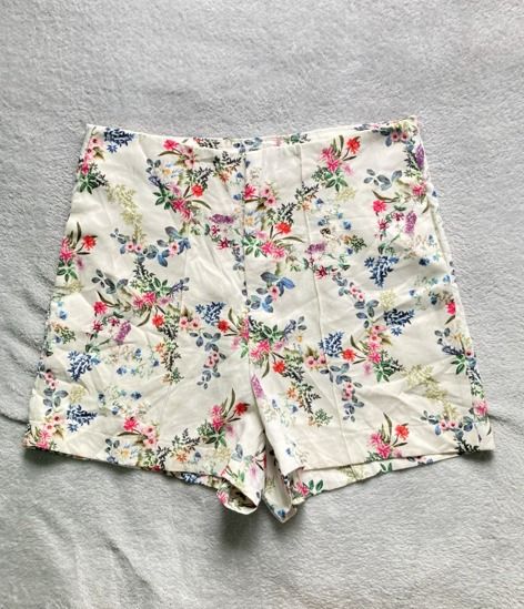 Floral High-Waisted Shorts (Category: Shorts) located in Rizal. Submitted by sheeraay (Listing ID 1467672416, Image 2). Description: - Style: High-waisted shorts with tailored front seams for a structured fit - Pattern: Vibrant floral print (pink, red, and blue flowers with green leaves) on a white background -waistlinw up to 15 inches - Fabric: Lightweight and breathable, ideal for warm weather - Condition: Excellent, ready to wear - Perfect for