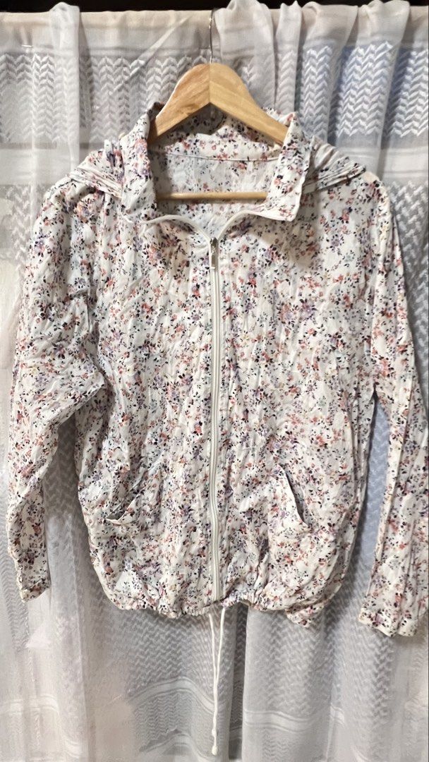 Floral Lightweight Zip-Up Hoodie Jacket (Category: Coats, Jackets and Outerwear) located in Pasig City. Submitted by morilove (Listing ID 1467702433, Image 1). Description: - Style: Lightweight zip-up hoodie imported from Japan - Design: White base with an all-over pink, purple, and black floral print - Features: Full front zipper, two front pockets, and white drawstrings at the hood and bottom hem - Fit: Long sleeves, easy layer for breezy weath
