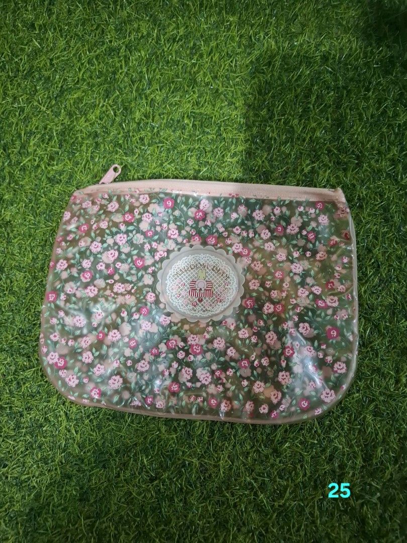 Floral pattern transparent zipper pouch with pink trim (Category: Purses & Pouches) located in Pasay City. Submitted by emilia1102 (Listing ID 1467800065, Image 1). Description: - Material: Clear plastic with a cute pink floral design and decorative center label - Closure: Smooth pink top zipper - Versatile: Great for everyday makeup, touch-up essentials, or stationery - Practical: Keeps your main bag organized and clutter-free - Easy Maintenance