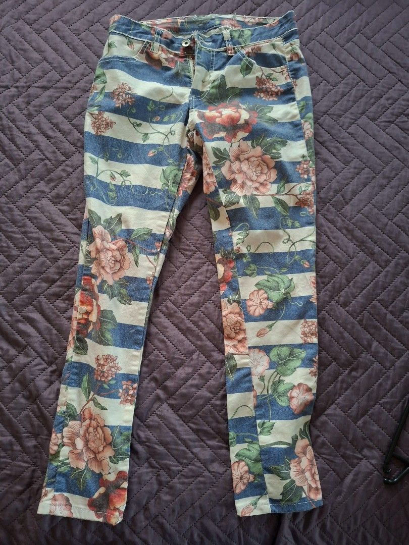 Floral stripe print casual pants (Category: Jeans) located in Las Pinas. Submitted by melsv (Listing ID 1467698414, Image 1). Description: - Design: Blue and cream stripes with a bold floral pattern overlay - Fit: Fitted style with a button waist and zipper fly closure - Style: Unique statement piece that stands out - Versatility: Great for casual outfits or making a fashion statement.