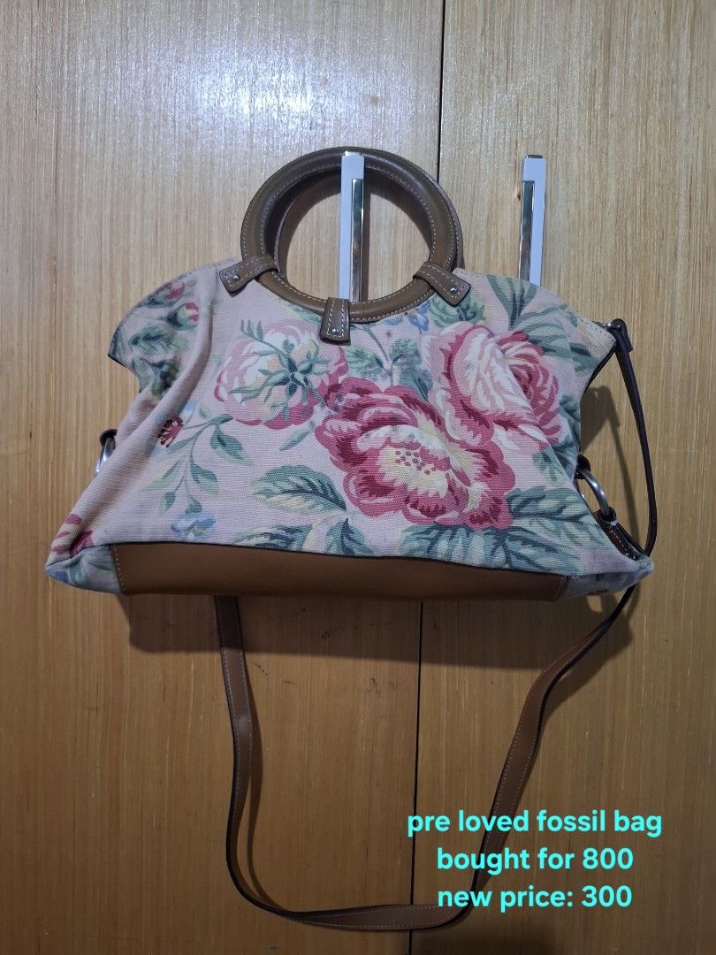 Fossil Floral Tapestry Shoulder Handbag (Category: Shoulder Bags) located in Pasay City. Submitted by emilia1102 (Listing ID 1467796527, Image 2). Description: - Brand: Fossil - Style: Shoulder bag / Crossbody bag - Material: Pink floral tapestry fabric with brown leather trim - Hardware: Silver-tone - Handles: Round top handles plus a matching brown leather crossbody strap - Condition: Pre-loved, well-maintained, and priced to sell!.