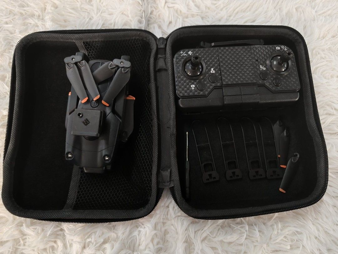 Four axis drone G5 (Category: Drones) located in Baguio. Submitted by gherszelle (Listing ID 1467701777, Image 1). Description: This compact, foldable hobby drone kit comes complete with a carbon-fiber textured remote controller, spare parts, and propeller guards. Everything is neatly organized in a durable, zippered carrying case, making it perfect for portable, on-the-go flying..