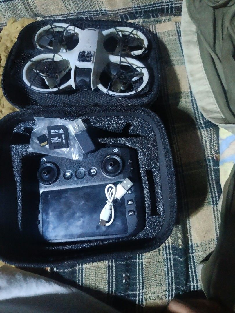 FPV Drone with Remote Controller and Carrying Case (Category: Drones) located in Davao. Submitted by greyyyy23 (Listing ID 1467782576, Image 1). Description: - Complete ready-to-fly compact drone setup - White quadcopter featuring protective propeller guards - Controller with built-in screen included - SanDisk memory card with USB adapter included - Charging cable included - Portable hard carrying case for easy and safe transport - Perfect all-in