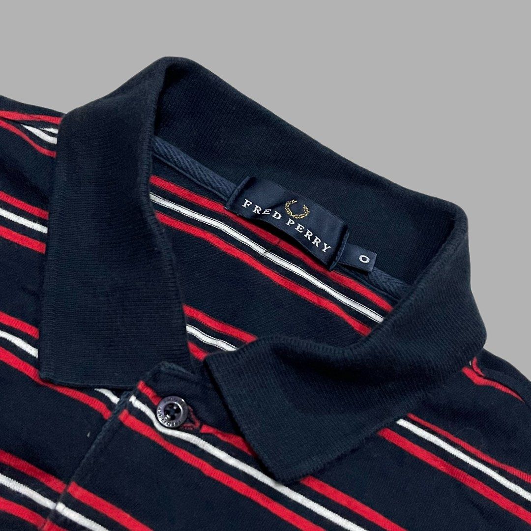Fred Perry Striped Polo Shirt Navy Red White (Category: Tshirts & Polo Shirts ) located in Manila. Submitted by frenzyyyy (Listing ID 1467627140, Image 3). Description: - Brand: Fred Perry - Color: Navy blue with red and white horizontal stripes - Details: Classic collar, two-button placket with branded buttons, ribbed sleeve cuffs - Logo: White embroidered laurel wreath on left chest - Material: Soft cotton knit - Size: Medium - Dimes: 21/27 - C