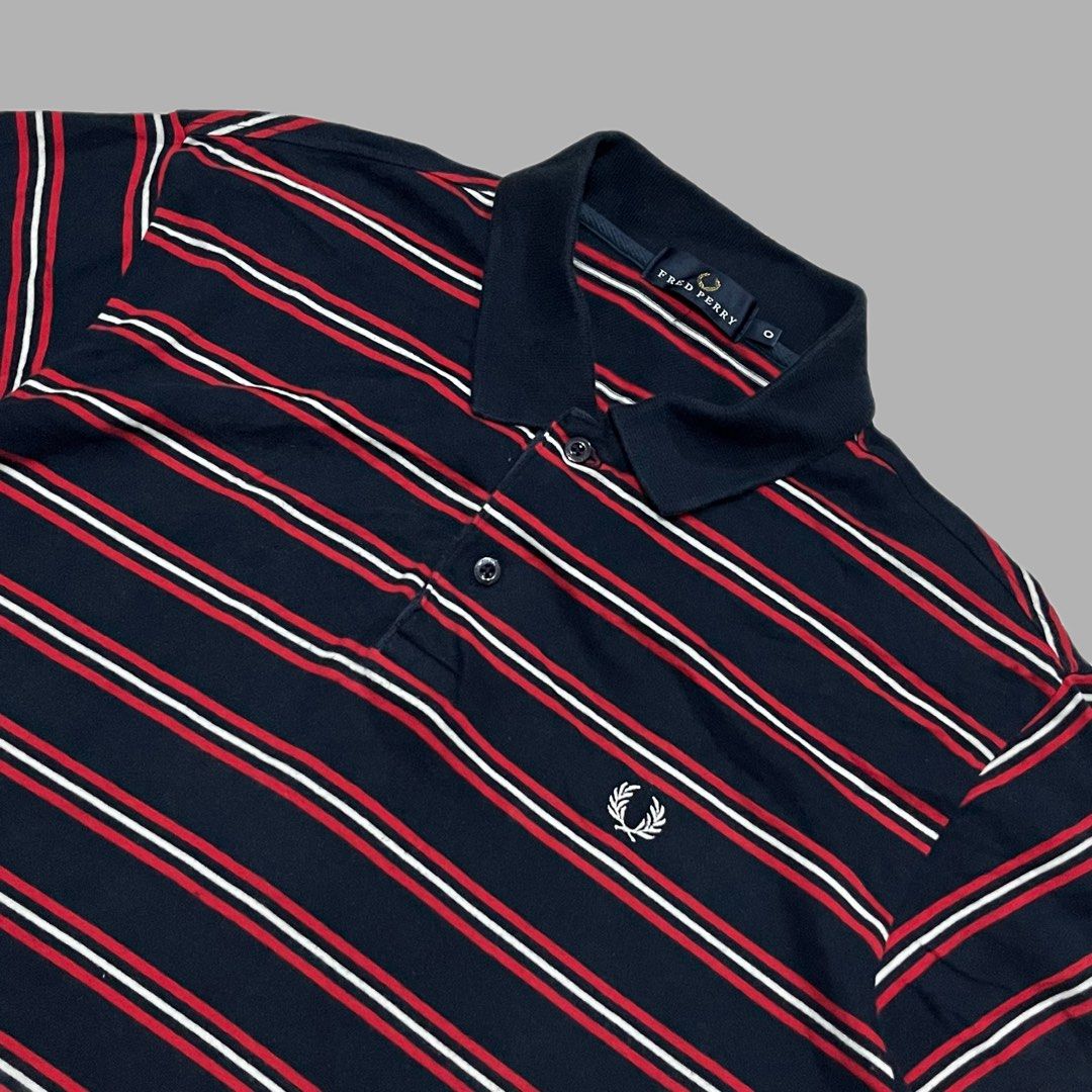 Fred Perry Striped Polo Shirt Navy Red White (Category: Tshirts & Polo Shirts ) located in Manila. Submitted by frenzyyyy (Listing ID 1467627140, Image 2). Description: - Brand: Fred Perry - Color: Navy blue with red and white horizontal stripes - Details: Classic collar, two-button placket with branded buttons, ribbed sleeve cuffs - Logo: White embroidered laurel wreath on left chest - Material: Soft cotton knit - Size: Medium - Dimes: 21/27 - C