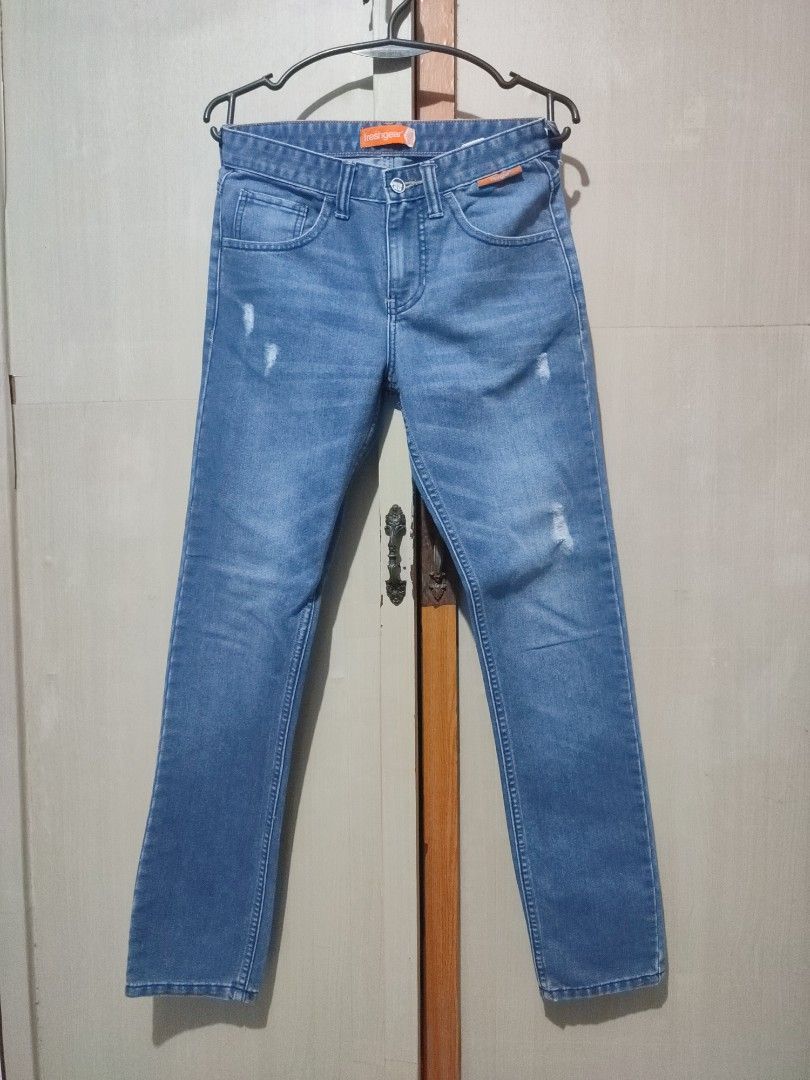 Freshgear Blue Denim Jeans Straight Cut (Category: Jeans) located in Manila. Submitted by jakelauren63238 (Listing ID 1467646007, Image 1). Description: - Brand: Freshgear - Color/Wash: Medium wash blue denim - Fit: Straight cut - Details: Subtle distressed accents on thighs, classic five-pocket style, button closure, standard belt loops, and signature orange logo tag inside the waistband - Style: Versatile and perfect for daily outfits.