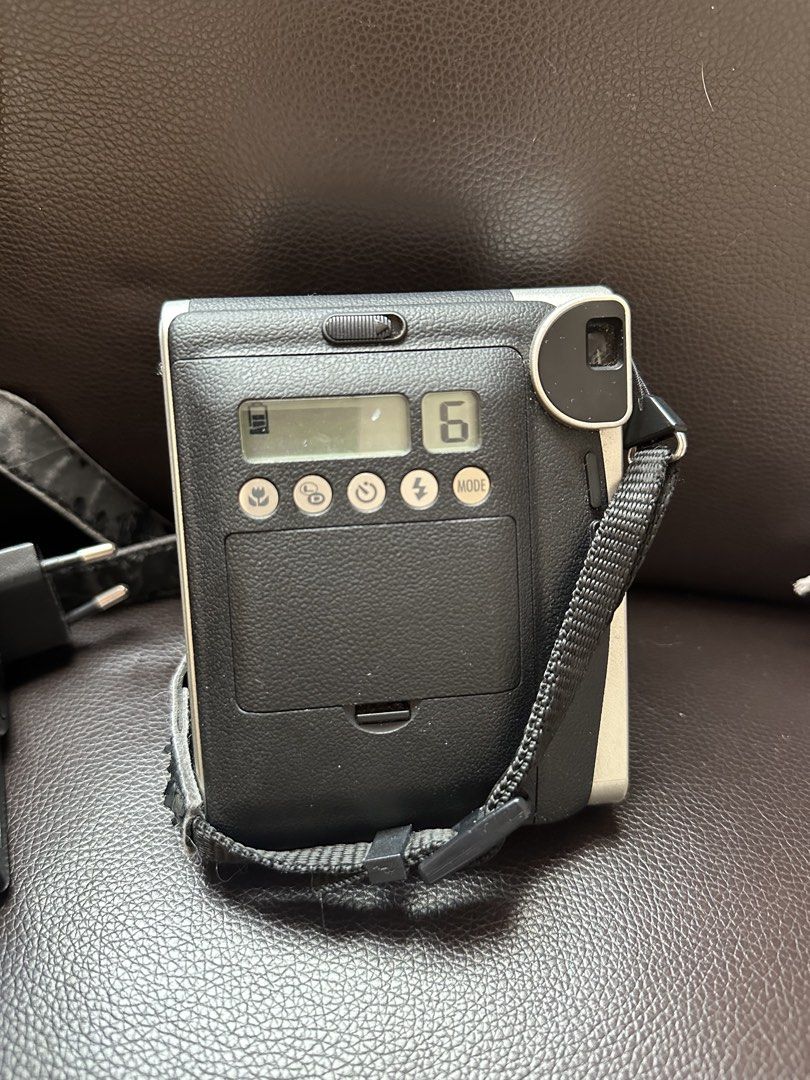 Fujifilm Instax Mini 90 Neo Classic Camera (Category: Cameras) located in Manila. Submitted by kanibear (Listing ID 1467673982, Image 3). Description: Tested and working. INCLUSIONS: - Camera - With strap (but medyo nagbabakbak na siya) - Charger, good as new (matagal battery ng cam na to so i wasn’t really able to use the charger as much - FREE: 5 leftover na film shots sa cam itself NOTE: Has slight scratches and dusts. Body shows minor signs o