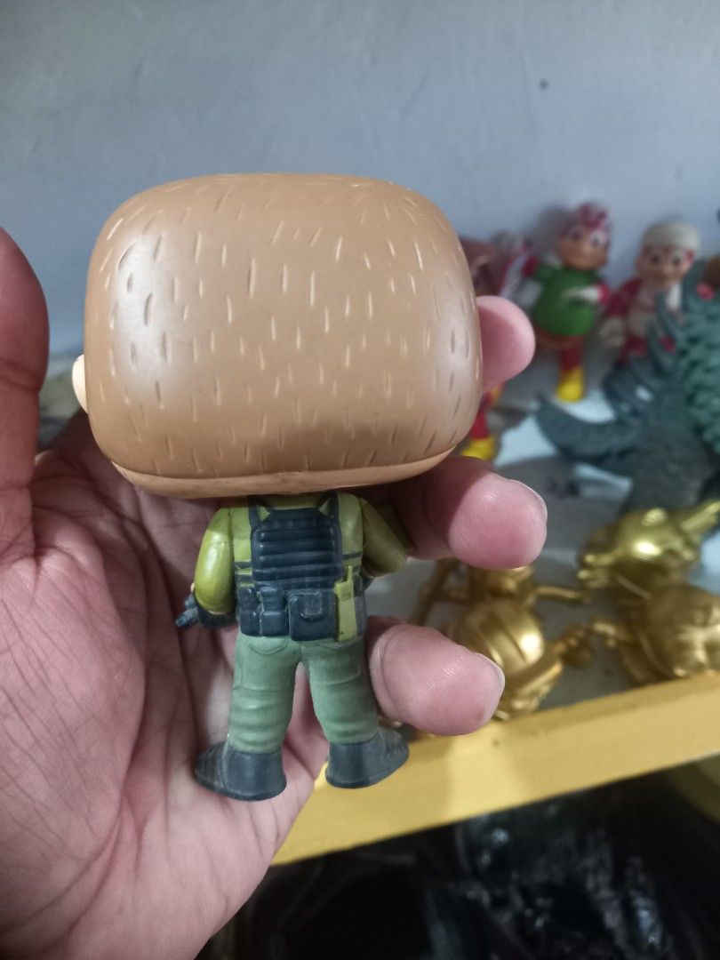Funko Pop Suicide squad Action Figure Rick Flag (Category: Designer & Blind Box Toys) located in Manila. Submitted by cristobalc40322 (Listing ID 1467696456, Image 3). Description: - Funko Pop military soldier collectible vinyl figure - Features green tactical uniform, vest, black boots, and rifle accessory - Detailed with brown hair and painted facial hair - Loose figure, sold without original packaging - Has minor scuff marks and dust accumulat