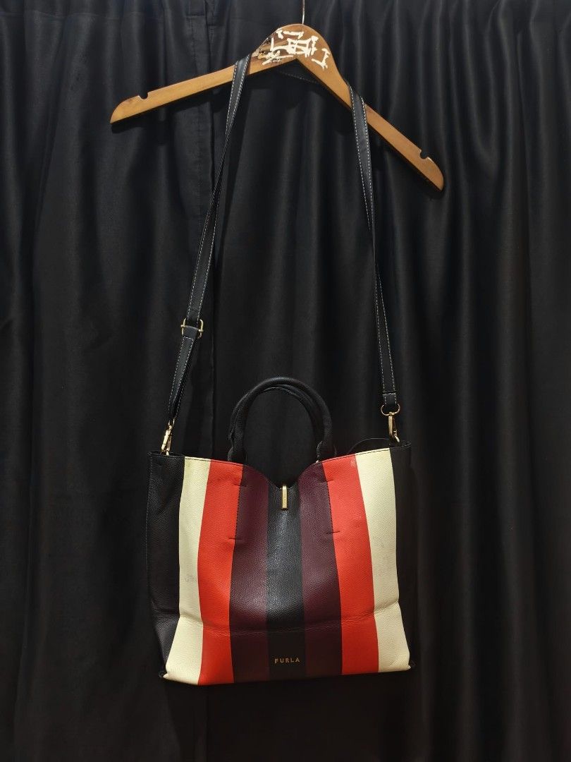 Furla Reversible Multi-Color Tote Handbag (Category: Tote Bags) located in Baguio. Submitted by solo_ukay (Listing ID 1467787325, Image 1). Description: Furla tote bag, multi-color striped design on one side and solid black on the other side. Genuine leather interior tag. Top carry handles plus a detachable, adjustable shoulder strap. Zip pocket inside. Gold-tone hardware. Reversible style gives two looks in one bag..