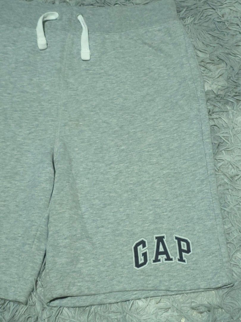 Gap Kids Grey Sweat Shorts (Category: Shorts) located in Abulug. Submitted by humanwhosellthings (Listing ID 1467728687, Image 2). Description: - Brand: Gap Kids ✅Excellent Condition ✅Issue: none ▫️Waist Size: 28-32 ▫️Length: 17 - Size: 160 cm (approx. 14 years) - Condition: Brand new with tags attached - Features: Elastic waistband with white drawstring, bold GAP logo on the leg, and cozy soft fleece lining inside - Ideal for: Casual lounging or