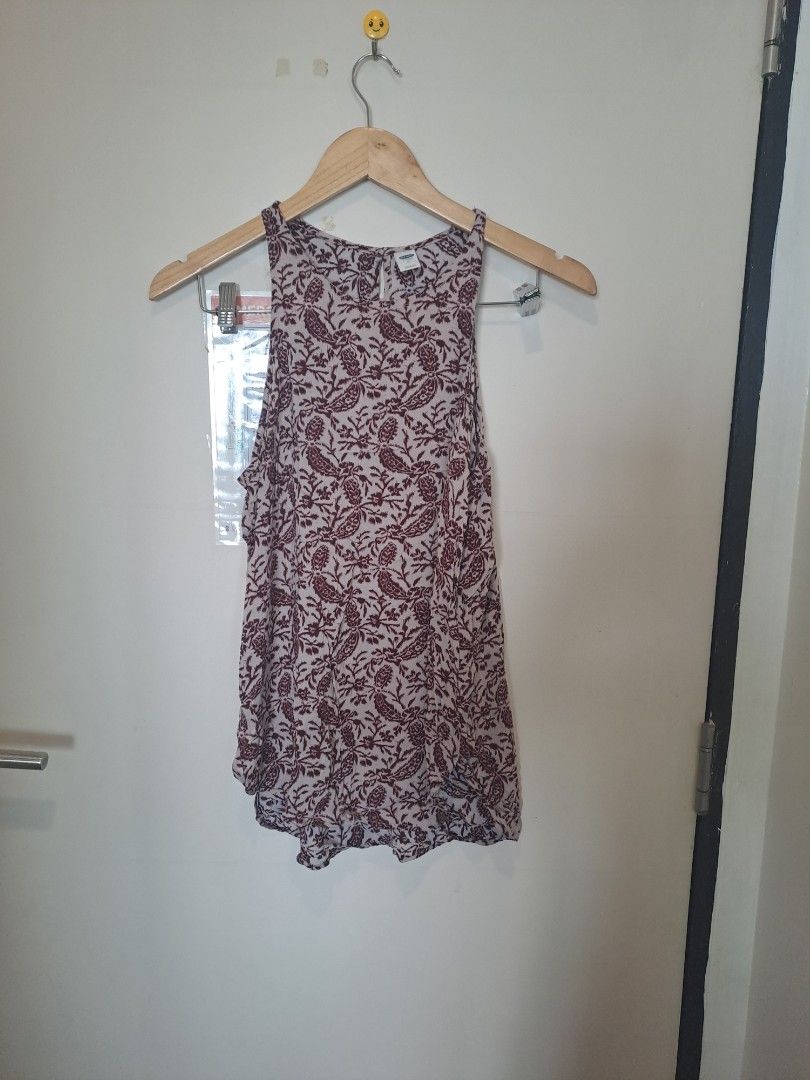 Gap paisley print sleeveless (Category: Sleeveless) located in Manila. Submitted by joanbalde39643 (Listing ID 1467658987, Image 1). Description: This is an Old Navy high-neck printed tank top featuring a maroon and cream floral paisley pattern. It is designed with a relaxed, flowy silhouette, high crew neck, and subtle racerback styling with a small keyhole button closure at the upper back..