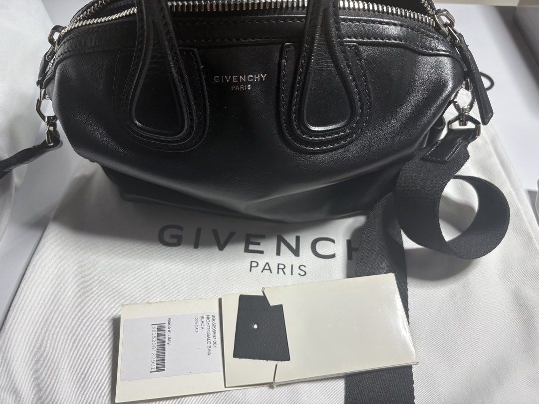 Givenchy Nightingale Black Leather Bag (Category: Luxury Bags & Wallets) located in Tanauan. Submitted by fiercedolphin_eef7ac (Listing ID 1467667803, Image 2). Description: - Brand: Givenchy Nightingale - Material: Premium black calf leather with silver-tone hardware - Straps: Dual top handles & detachable webbed shoulder strap with bold white logo lettering - Closure: Secure zip top closure - Interior: Black fabric lining with official serial n