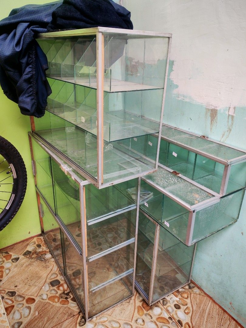 Glass display cabinet shelf rack retail storage unit (Category: Shelves, Cabinets & Racks) located in Quezon City. Submitted by shie_123 (Listing ID 1467705702, Image 1). Description: TAKE ALL 4 Glass Stante for only 3500 pesos ... all goods .. Pick up only.. North Caloocan .