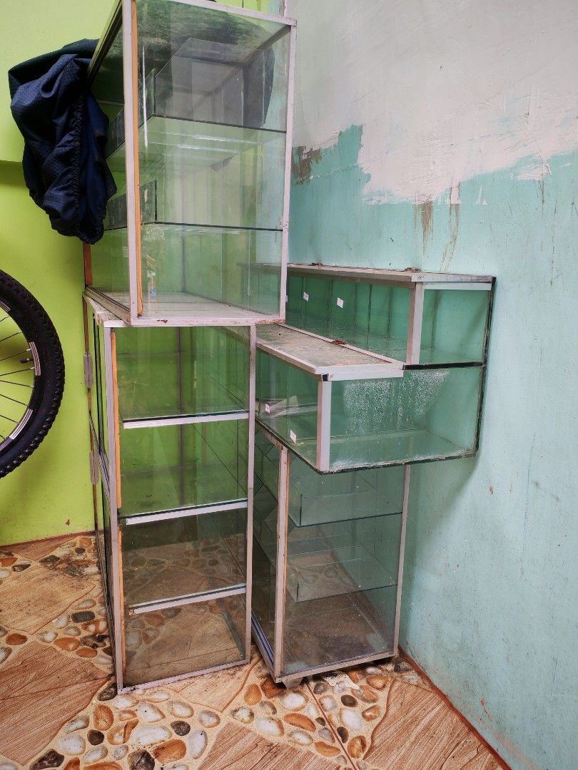 Glass display cabinet shelf rack retail storage unit (Category: Shelves, Cabinets & Racks) located in Quezon City. Submitted by shie_123 (Listing ID 1467705702, Image 2). Description: TAKE ALL 4 Glass Stante for only 3500 pesos ... all goods .. Pick up only.. North Caloocan .