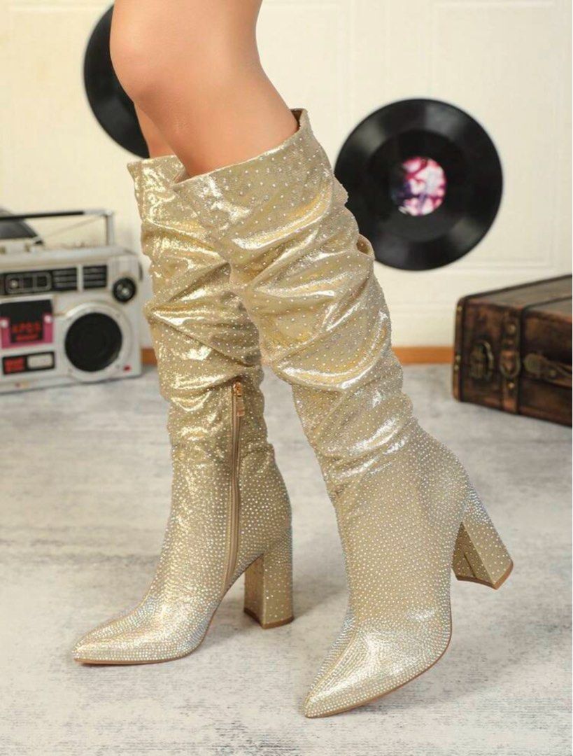 Gold Rhinestone Slouchy Heeled Boots (Category: Boots) located in Pasig City. Submitted by lai028 (Listing ID 1467747832, Image 2). Description: Used once for an event, like brand new - Color/Finish: Sparkling gold covered in all-over rhinestones - Heel: Chunky high block heel - Toe: Pointed toe design - Closure: Side zipper for easy wear - Fit: Mid-calf slouchy fit - Style: High glamour, catches the light everywhere, perfect for parties.