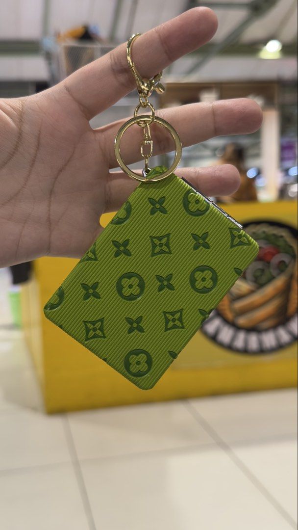Green Monogram Pattern Foldable Pocket Mirror with Keychain (Category: Mirrors) located in Taguig. Submitted by seek_and_ship (Listing ID 1467715955, Image 1). Description: Bright lime green pocket mirror with debossed monogram pattern. Opens up to dual mirrors inside. Silver tone metal frame. Attached gold tone keychain ring, clip it right onto your bag or keys. Compact size, easy to throw in a pouch or purse for quick touch-ups on the go..