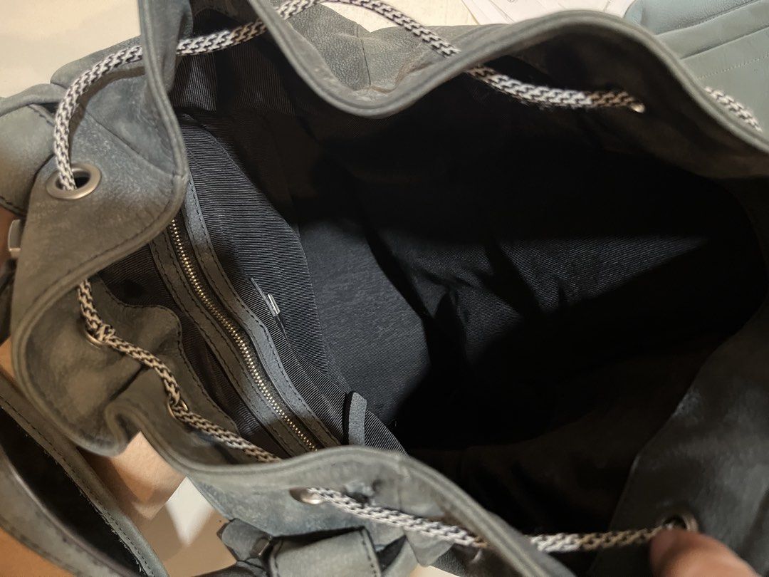 Grey Leather Bucket with Drawstring and Zippers (Category: Backpacks) located in Bacolod City. Submitted by vintage_vogue6100 (Listing ID 1467761286, Image 2). Description: - Color: Grey - Material: Leather with dark fabric lining - Closure: Drawstring - Pockets: Front zip pockets and interior zip compartments - Handles: Sturdy top handles attached - Dimensions: 29cm (H) x 33cm (L) x 14cm (W) - Condition: Clean interior - Origin: Design by Korea.