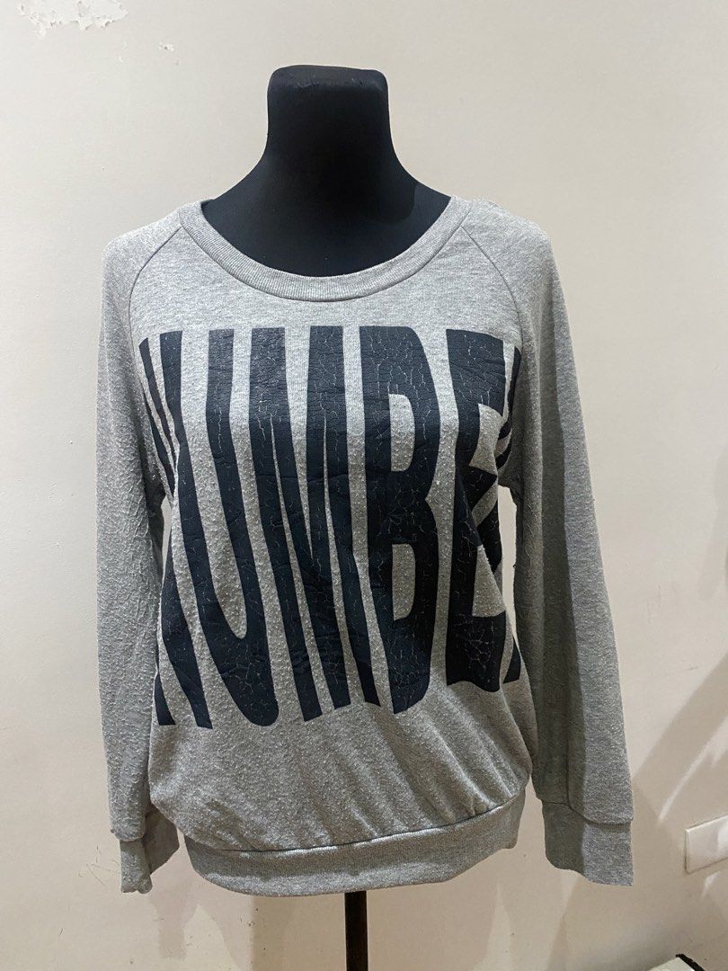 Grey Long Sleeve Sweatshirt with Number Print (Category: Longsleeves) located in Manila. Submitted by mpt99876 (Listing ID 1467795951, Image 1). Description: Grey long sleeve sweatshirt with large black number graphic printed across the front. Crew neckline with ribbed cuffs and hem. Relaxed fit style, great for casual days. Fabric shows normal piling throughout from previous wear..