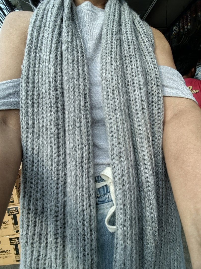 Grey ribbed knit scarf winter accessory 250cm (Category: Scarves) located in Paranaque City. Submitted by furugiyafinds (Listing ID 1467689903, Image 1). Description: - Color: Versatile neutral grey - Design: Classic ribbed knit pattern - Material: Soft, thick textured fabric for maximum warmth - Fit: Extra long to wrap around multiple times - Style: Easy to pair with any winter coat or jacket - Condition: Brand new / Great staple piece.