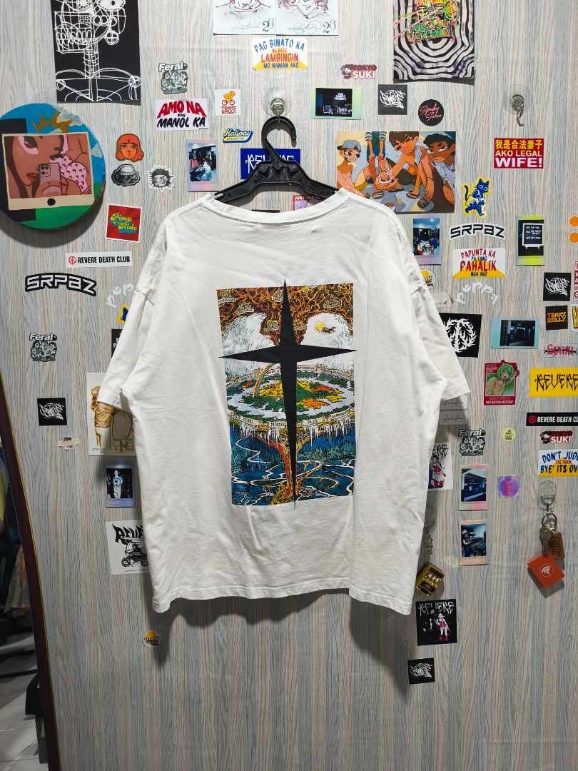 GRKC "Utopia" Tee (Category: Tshirts & Polo Shirts ) located in Davao. Submitted by thethriftproject082 (Listing ID 1467795123, Image 3). Description: GRKC "Utopia" Tee 📍𝐌𝐈𝐍𝐄: 400 📍𝐒𝐈𝐙𝐄 𝐎𝐍 𝐓𝐀𝐆: L 📍𝐃𝐈𝐌𝐄𝐒: 24 x 28 - Color: White - Fit: Oversized / Relaxed fit - Details: Small black cross embroidery on chest, vibrant Norse tree graphic on the back - Sleeves: Short sleeves - Style: Streetwear, easy to style with jeans or cargo pa