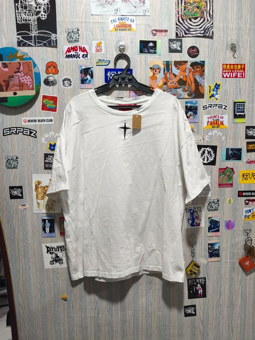 GRKC "Utopia" Tee (Category: Tshirts & Polo Shirts ) located in Davao. Submitted by thethriftproject082 (Listing ID 1467795123, Image 1). Description: GRKC "Utopia" Tee 📍𝐌𝐈𝐍𝐄: 400 📍𝐒𝐈𝐙𝐄 𝐎𝐍 𝐓𝐀𝐆: L 📍𝐃𝐈𝐌𝐄𝐒: 24 x 28 - Color: White - Fit: Oversized / Relaxed fit - Details: Small black cross embroidery on chest, vibrant Norse tree graphic on the back - Sleeves: Short sleeves - Style: Streetwear, easy to style with jeans or cargo pa