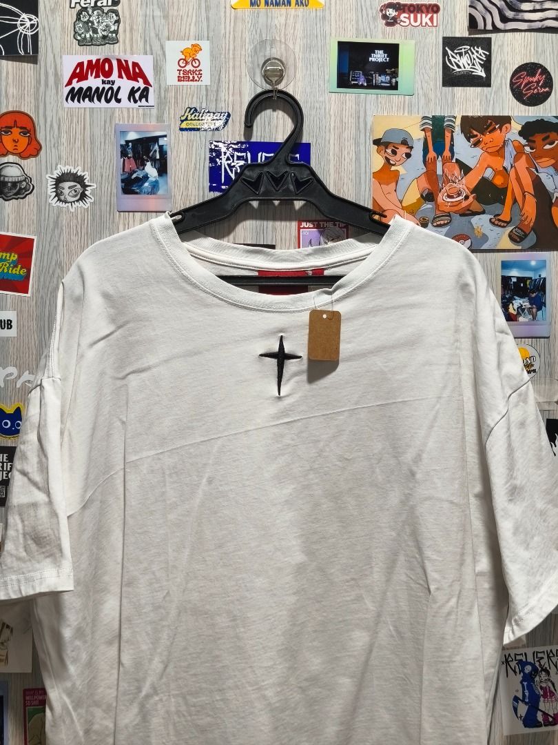 GRKC "Utopia" Tee (Category: Tshirts & Polo Shirts ) located in Davao. Submitted by thethriftproject082 (Listing ID 1467795123, Image 2). Description: GRKC "Utopia" Tee 📍𝐌𝐈𝐍𝐄: 400 📍𝐒𝐈𝐙𝐄 𝐎𝐍 𝐓𝐀𝐆: L 📍𝐃𝐈𝐌𝐄𝐒: 24 x 28 - Color: White - Fit: Oversized / Relaxed fit - Details: Small black cross embroidery on chest, vibrant Norse tree graphic on the back - Sleeves: Short sleeves - Style: Streetwear, easy to style with jeans or cargo pa