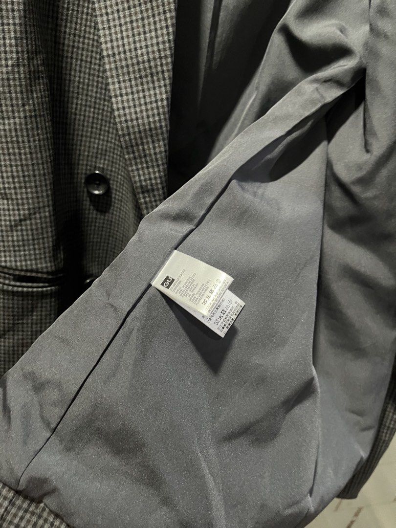 GU Grey Plaid Double-Breasted Blazer Size L (Category: Coats, Jackets and Outerwear) located in Makati City. Submitted by grizzlybear95 (Listing ID 1467734724, Image 3). Description: - Brand: GU - Style: Double-breasted blazer in a classic grey plaid pattern - Size: L (Tag attached at collar) - Features: Fully lined, functional front flap pockets, and dark front buttons - Fit: Structured silhouette, great for office wear or layering - Condition: 