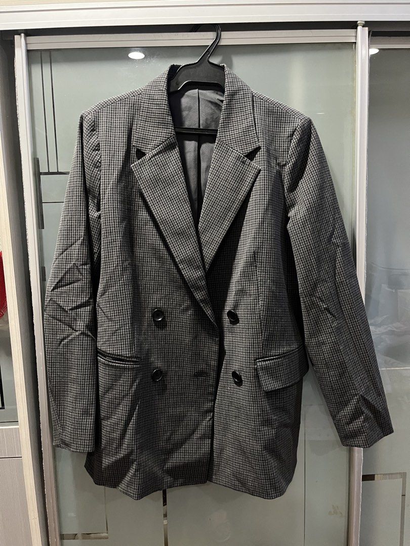 GU Grey Plaid Double-Breasted Blazer Size L (Category: Coats, Jackets and Outerwear) located in Makati City. Submitted by grizzlybear95 (Listing ID 1467734724, Image 1). Description: - Brand: GU - Style: Double-breasted blazer in a classic grey plaid pattern - Size: L (Tag attached at collar) - Features: Fully lined, functional front flap pockets, and dark front buttons - Fit: Structured silhouette, great for office wear or layering - Condition: 